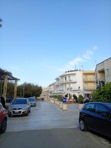 a parking lot with cars parked in front of buildings at Maison d'O in Otranto