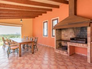 a dining room with a table and a fireplace at Ses Mires in Santanyi
