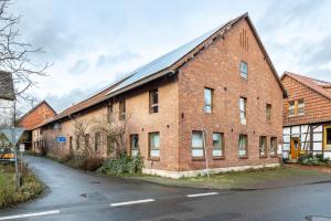a large brick building with a road in front of it at Offene Galerie-Fewo auf 2 Etagen in Bad Gandersheim