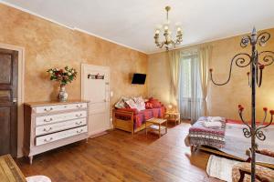 a bedroom with a bed and a dresser at La Belle Gabarre in Groléjac