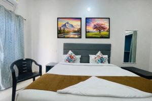 a hotel room with two beds and a window at Hotel The regal inn in Varanasi