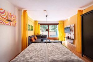 a bedroom with a bed and a living room at Waldquartier in Schönwald +17 photos