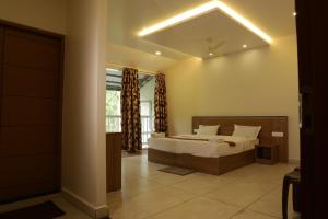 a bedroom with a bed and a window at Eden Holidays EV in Munnar +94 photos