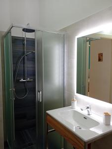 a bathroom with a shower and a sink and a mirror at Maison d'O in Otranto +23 photos