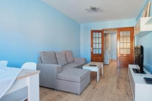 a living room with a couch and a table at Vivienda Turística Osiris in San Andrés del Rabanedo