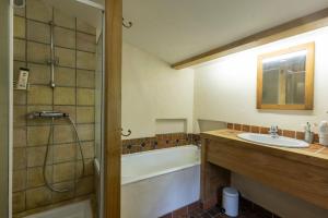 a bathroom with a sink and a tub and a shower at Les Grisiéres in Montpezat-sous-Bauzon +34 photos