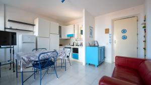 a kitchen with a table and chairs in a room at La Casa di Lucia in Marcelli