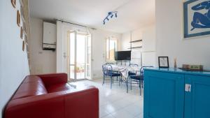 a living room with a red couch and a table at La Casa di Lucia in Marcelli