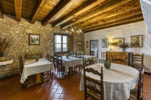 a dining room with tables and chairs in a building at La Torre de Dalt in Santa María de Camós