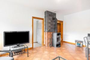 a living room with a flat screen tv on a table at Fewo am See in Olsberg