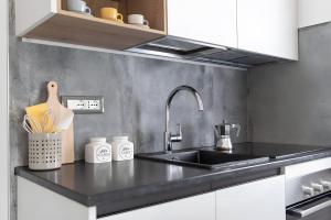 a kitchen with a sink and a counter top at Barrosu Studio Apartment in Orosei
