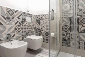 a bathroom with a toilet and a sink and a shower at Barrosu Studio Apartment in Orosei