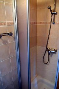 a shower with a glass door in a bathroom at Gite De Cabrières in Compeyre +15 photos