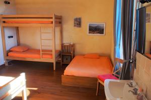 a bedroom with two bunk beds and a sink at Gite De Cabrières in Compeyre