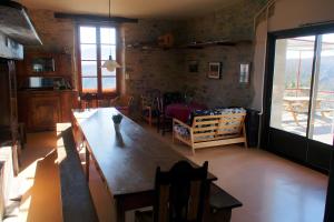 a living room with a table and a dining room at Gite De Cabrières in Compeyre