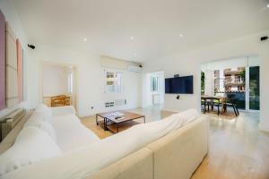 a living room with a white couch and a table at Ca Nostra in Port d'Andratx