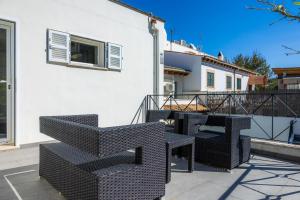 a balcony with chairs and tables on a building at Ca Nostra in Port d'Andratx