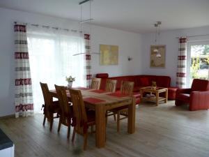 a living room with a table and chairs and a couch at Ankerhaus mit Sauna und Kamin in Karlshagen