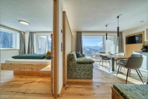a bedroom with a bed and a dining room at Hinterrainer Nature Apartments- New in Avelengo