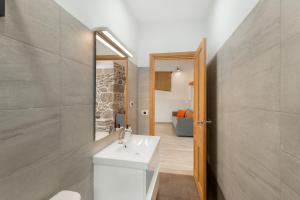 a bathroom with a white sink and a mirror at El Blanquizal B in San Nicolás +16 photos