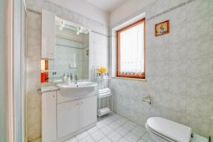 a white bathroom with a sink and a toilet at Umbria Casavacanze Vista Panoramica in Montefranco +36 photos