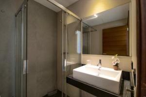 a bathroom with a sink and a shower and a mirror at Naturamar in Muro +10 photos