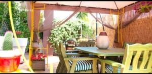 a patio with a table and chairs and an umbrella at Bnb Sottosopra intero 3 stanze 8pax in Gallipoli