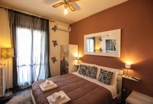 a bedroom with a bed and a large window at Bnb Sottosopra intero 3 stanze 8pax in Gallipoli +11 photos