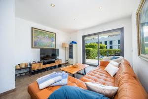 a living room with a couch and a tv at Bergantin 7 in Port de Pollensa