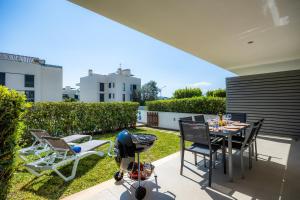 a patio with a table and chairs and a baby stroller at Bergantin 7 in Port de Pollensa