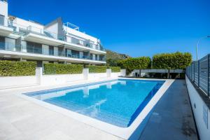 a swimming pool in front of a building at Bergantin 7 in Port de Pollensa