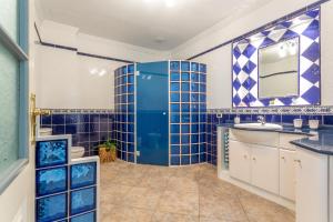 a blue tiled bathroom with a toilet and a sink at Crisol Apartamento in Puerto de la Madera +21 photos