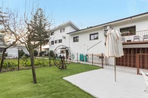 a garden with an umbrella and a playground at Casa São Domingos 1 in Lousada