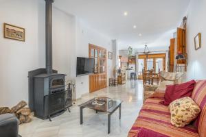 a living room with a couch and a fireplace at Casa El Naranjo Azul Granada in Lecrin