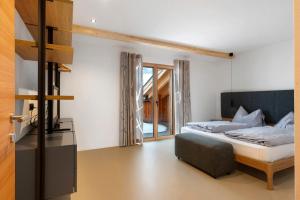 a bedroom with a bed and a chair in it at Appartement Mia in San Genesio Atesino