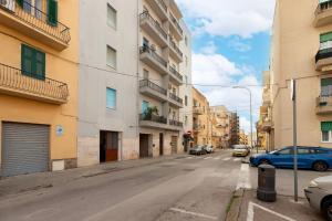 an empty street in a city with buildings at Emmeci House in Alghero