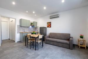a living room with a table and a couch at Emmeci House in Alghero