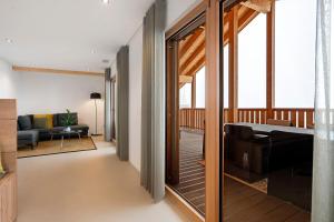 a hallway with a living room and a piano in a house at Appartement Mia in San Genesio Atesino