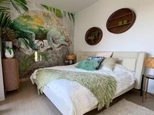 a bedroom with a bed with a dinosaur mural on the wall at Barcelona 11 in Finestrat +19 photos