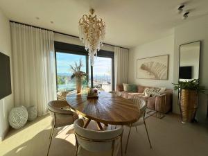 a living room with a dining table and a chandelier at Barcelona 11 in Finestrat