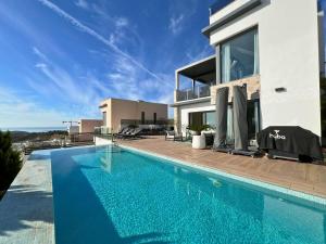 a swimming pool in front of a villa at Barcelona 11 in Finestrat