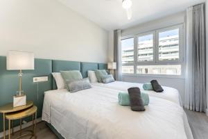 two twin beds in a room with a window at 250 La Cala Calaserena in La Cala de Mijas +17 photos