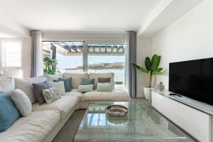 a living room with a white couch and a tv at 250 La Cala Calaserena in La Cala de Mijas