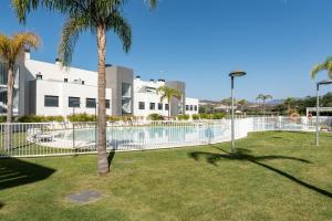 a fence around a swimming pool in front of a building at 250 La Cala Calaserena in La Cala de Mijas