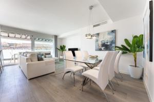 a dining room and living room with a table and chairs at 250 La Cala Calaserena in La Cala de Mijas