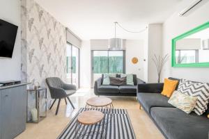 a living room with a couch and a table at Villa Sam 3 in Can Picafort