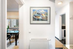 a kitchen and dining room with a picture on the wall at Ferienwohnung Aachen Süd in Aachen