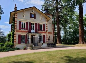 an old house with red and white trim at Chambre D'hôte - Le Chalêt in Ygrande