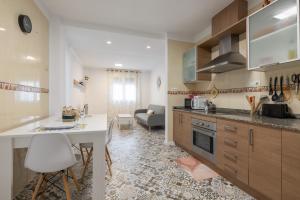 a kitchen with a counter and a table in a room at Casa Cinta in Deltebre