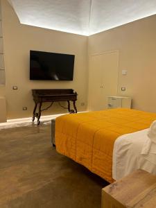 a bedroom with a bed and a flat screen tv at Suite di Bianca in Foligno